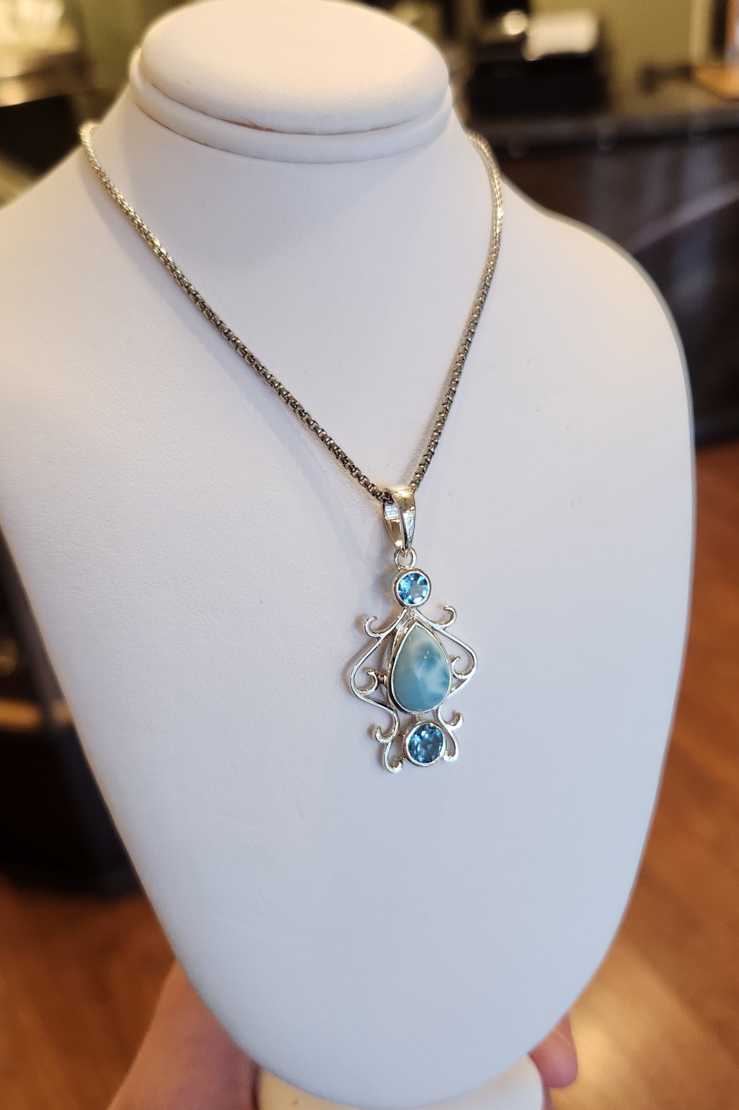 Sterling silver pear-shaped larimar pendant with blue topaz