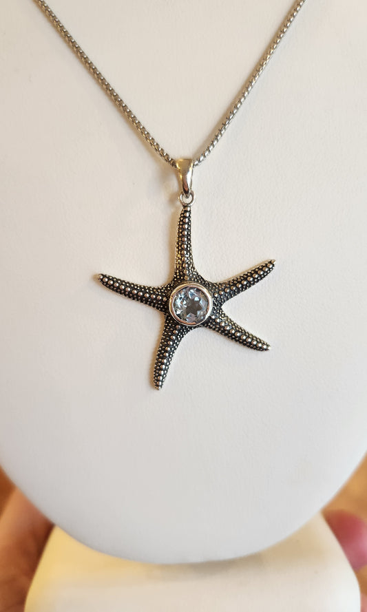 Sterling silver starfish pendant with blue topaz