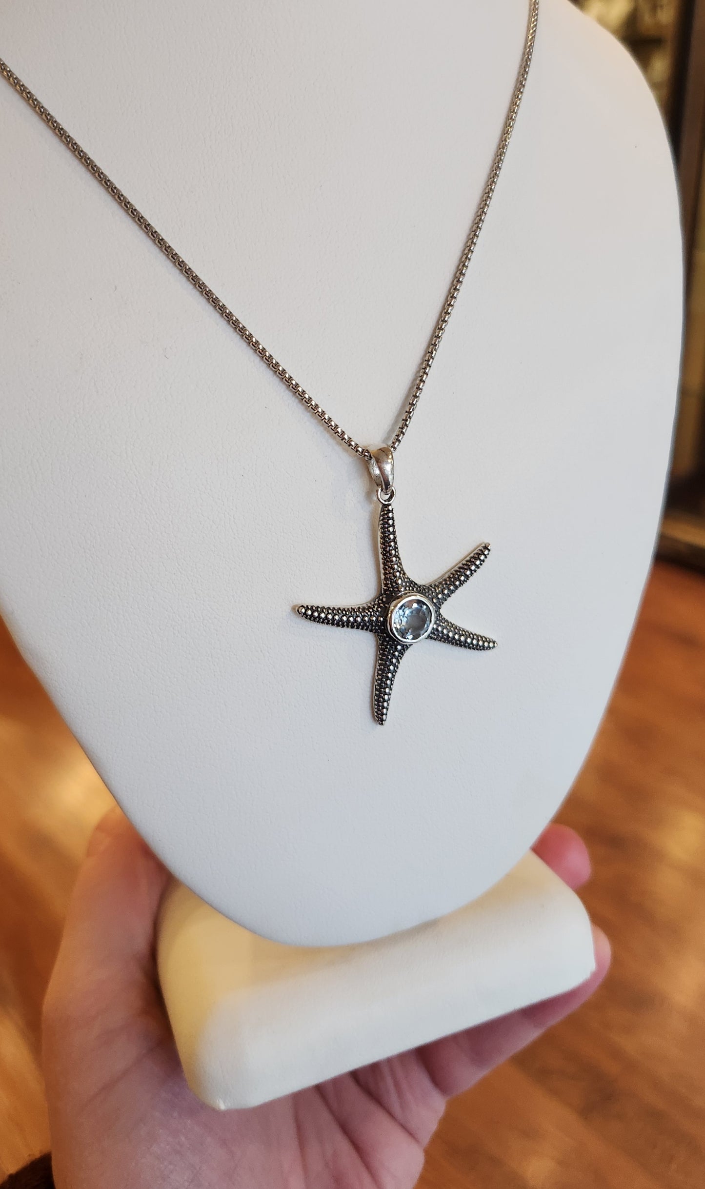 Sterling silver starfish pendant with blue topaz