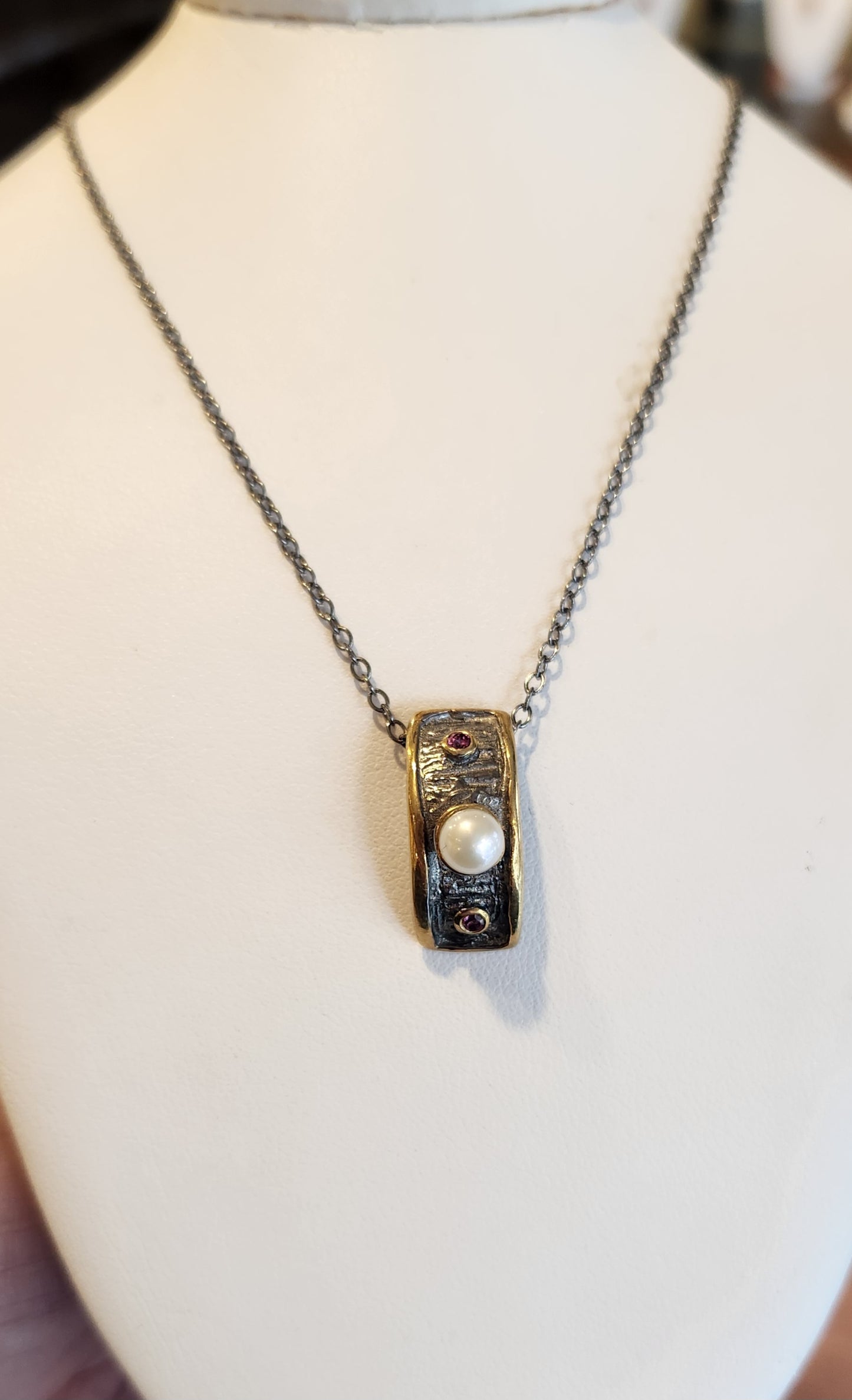 Oxidized sterling silver pendant with pearl, sapphires, and gold accents