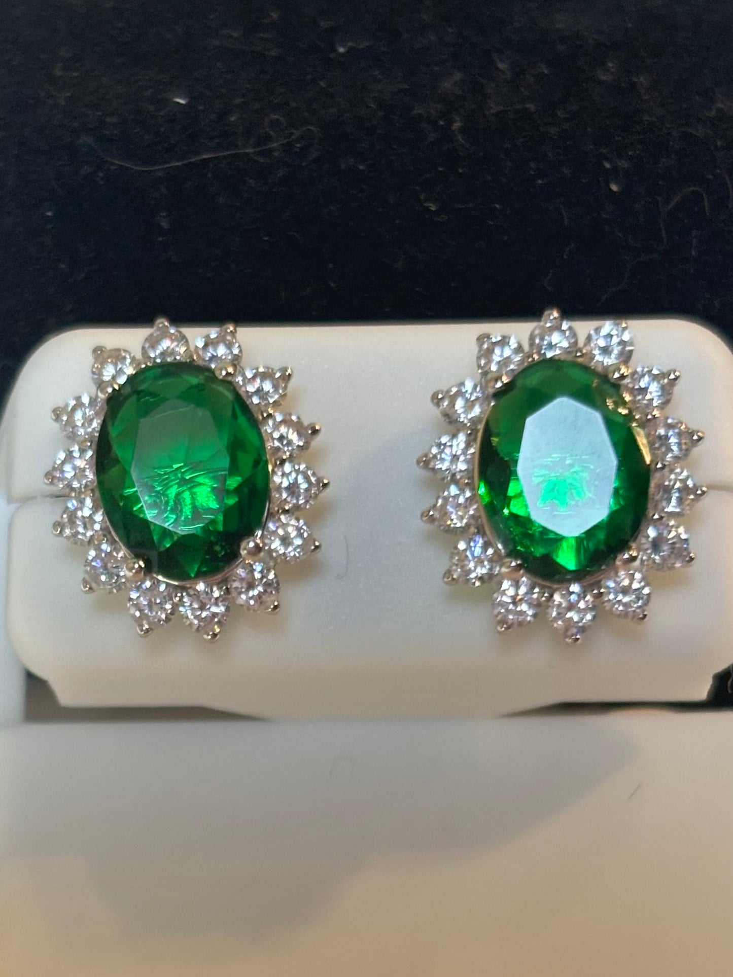 Sterling silver oval emerald halo stud earrings