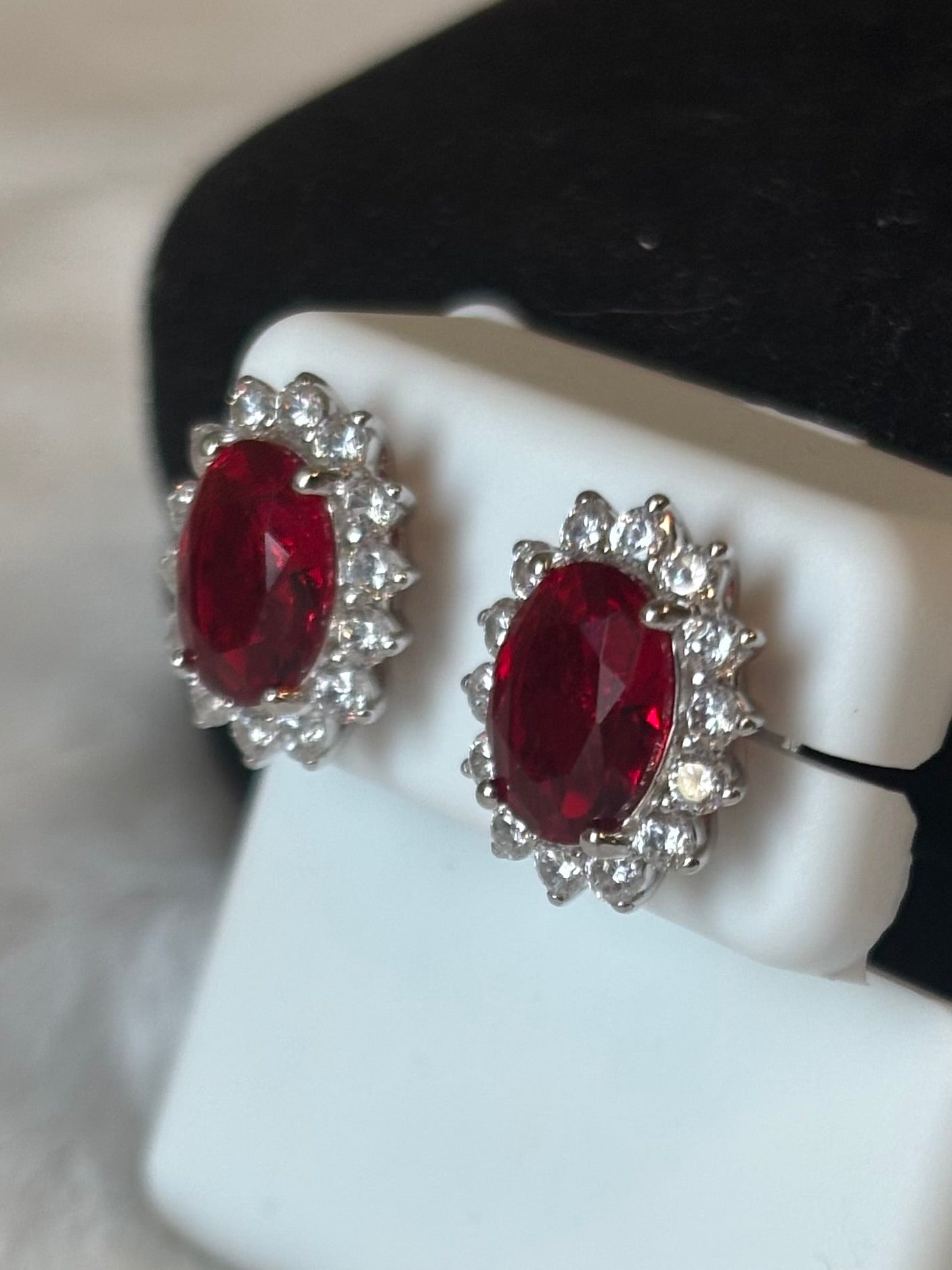 Sterling silver oval ruby halo stud earrings