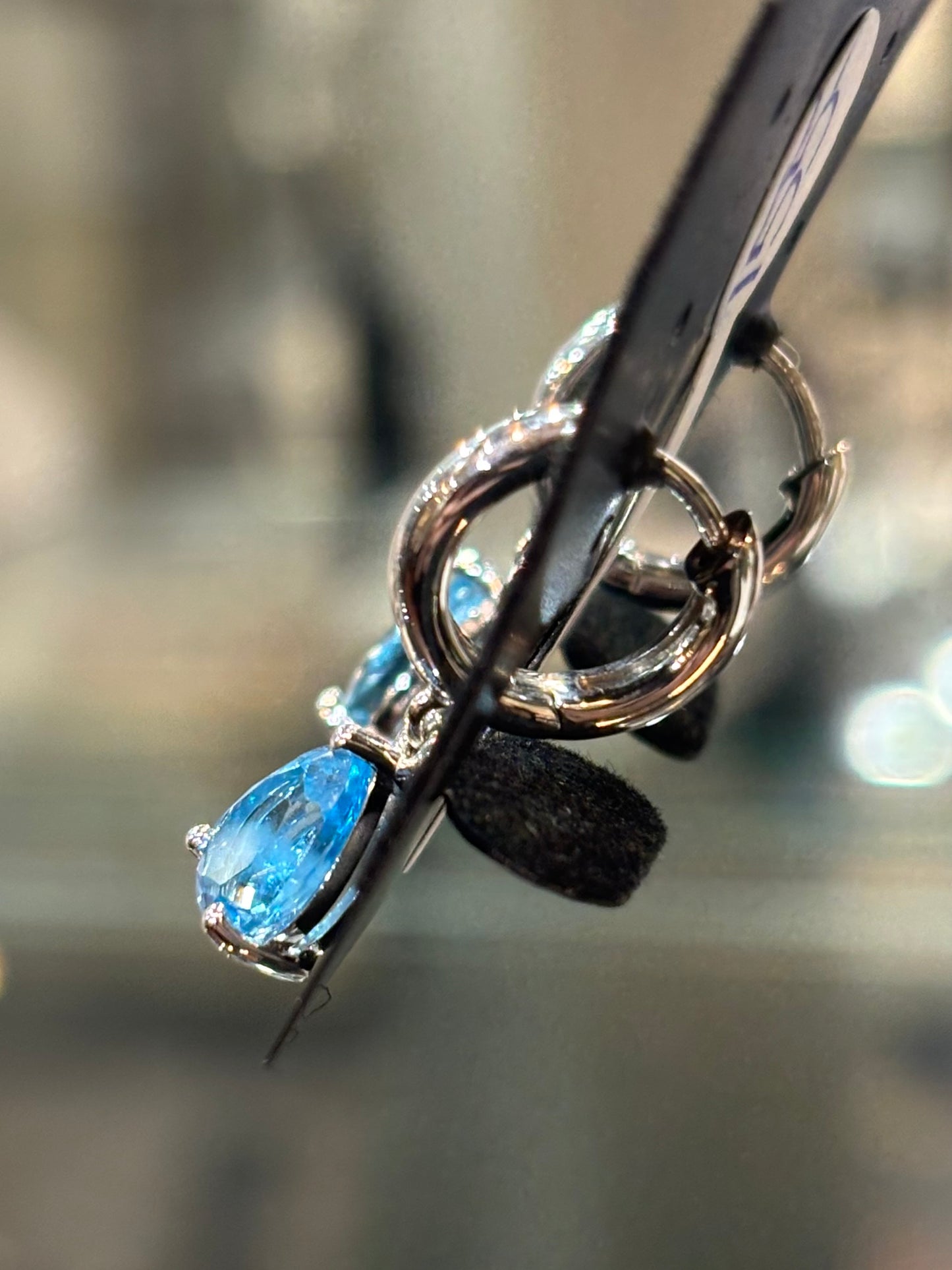 Sterling silver pear shaped blue topaz dangle hoop earrings