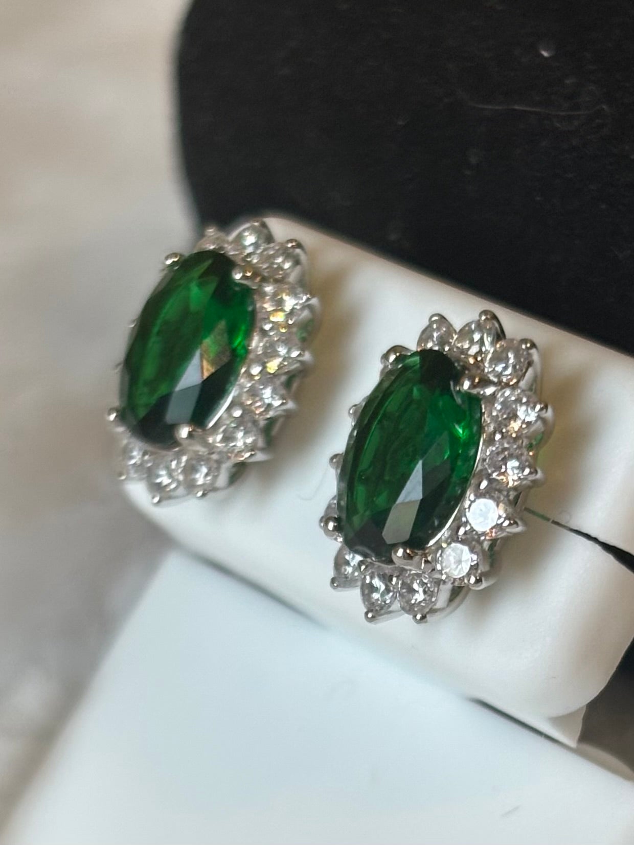 Sterling silver oval emerald halo stud earrings