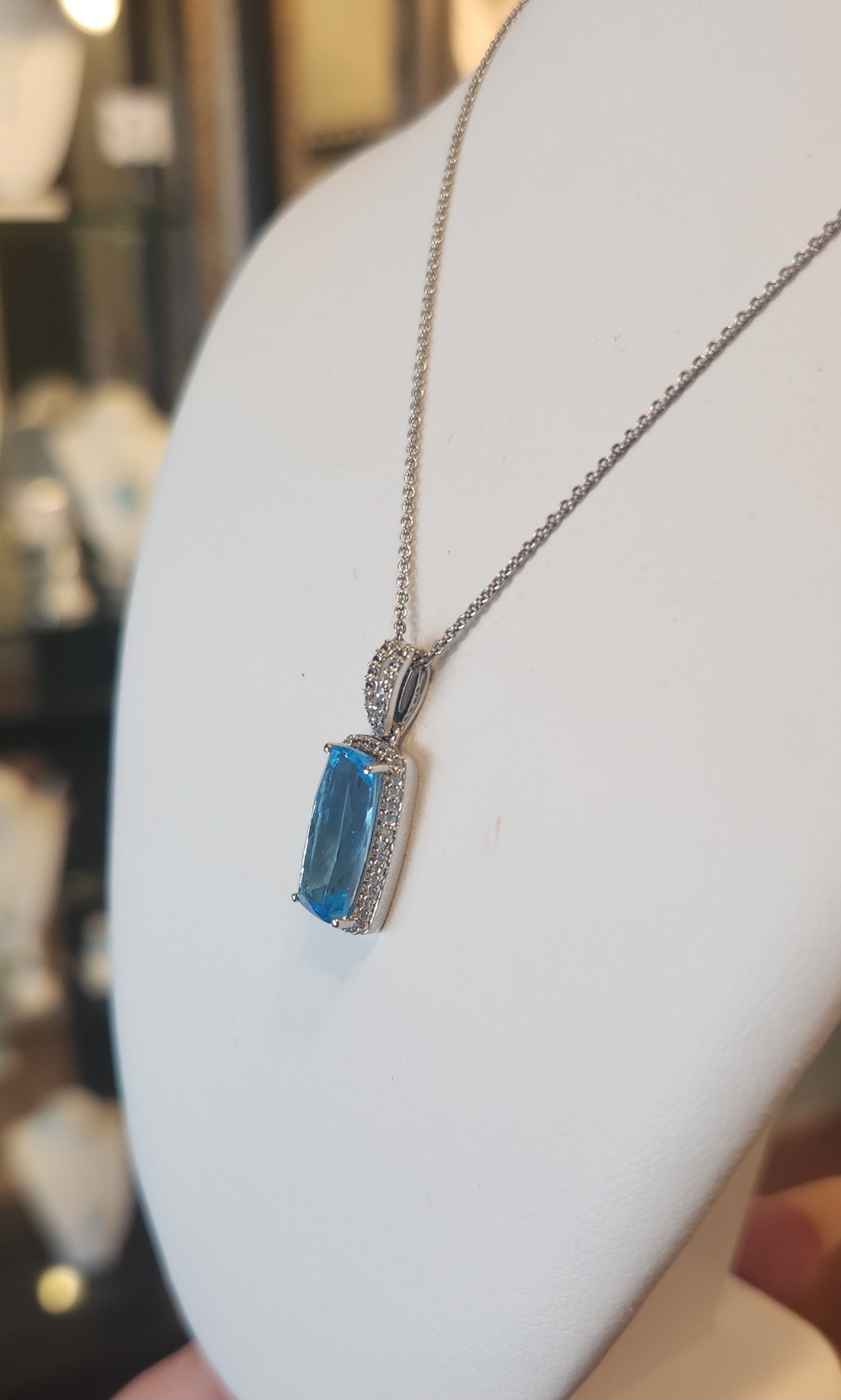 Sterling silver elongated rectangle blue topaz pendant with diamonds