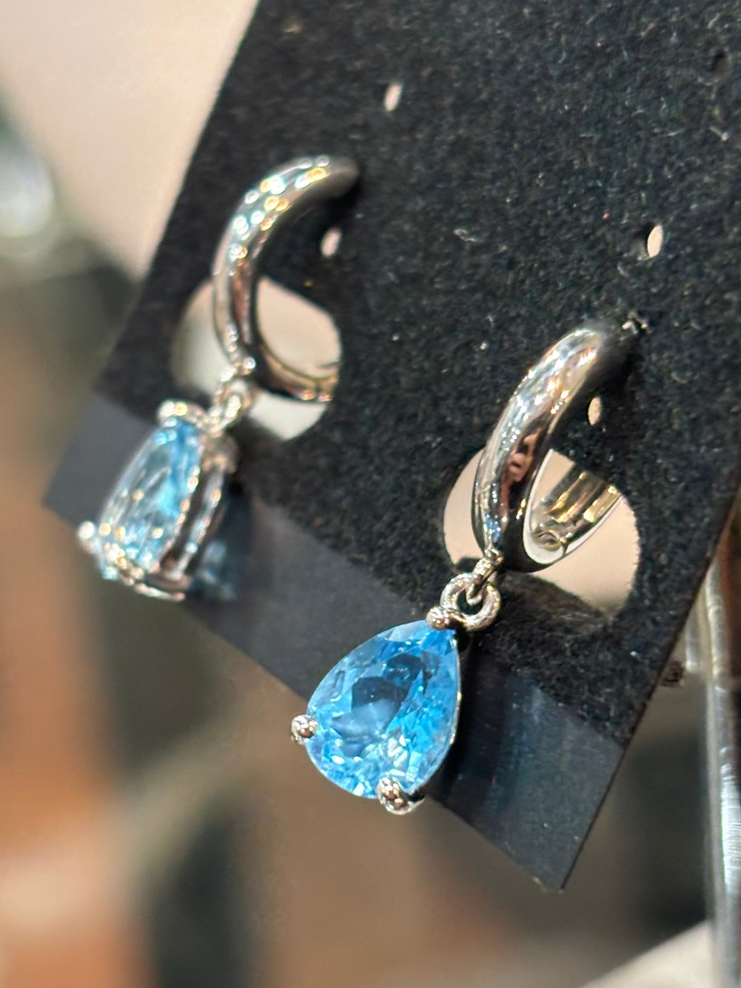 Sterling silver pear shaped blue topaz dangle hoop earrings