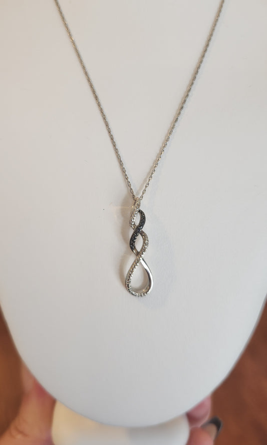 Sterling silver twist pendant with black and white diamonds