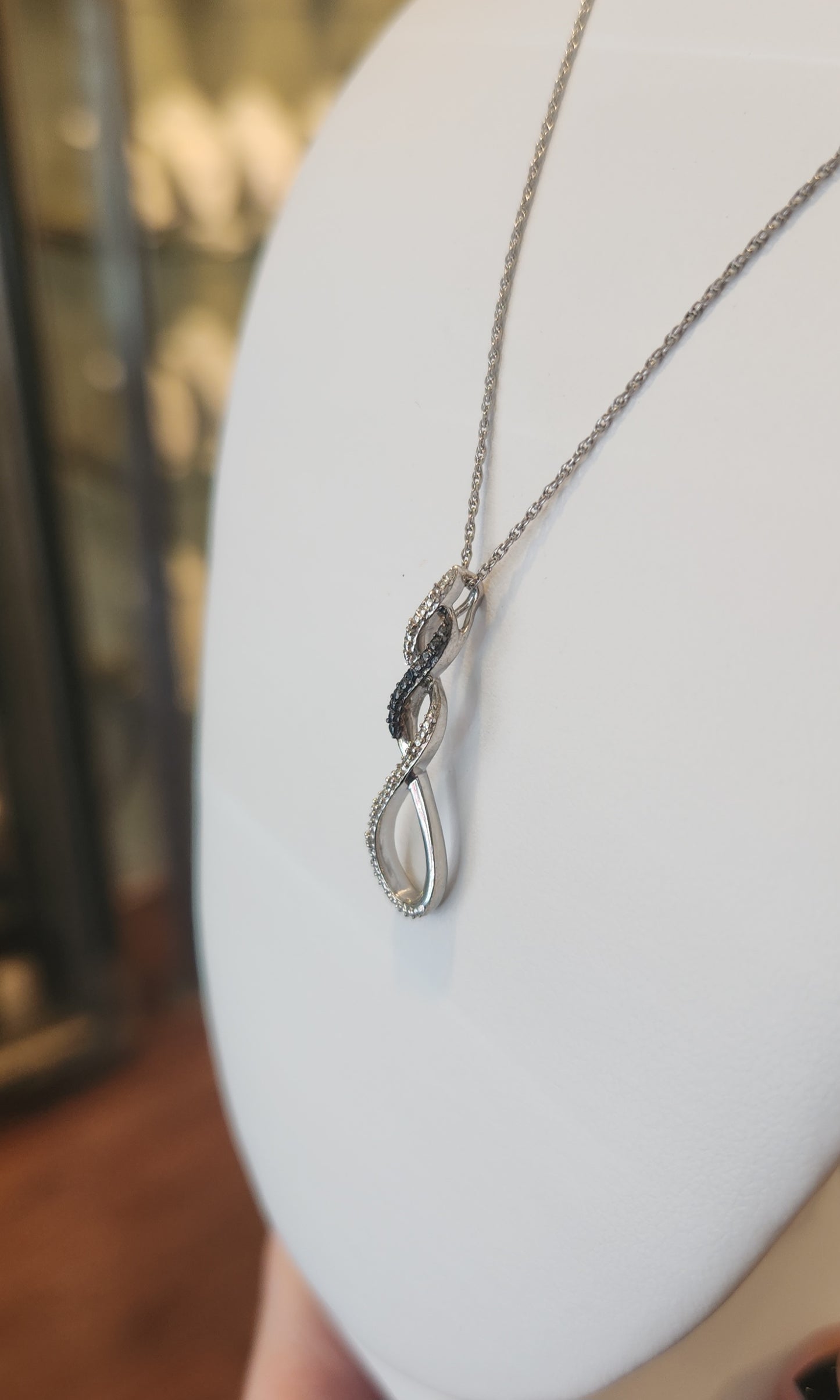 Sterling silver twist pendant with black and white diamonds