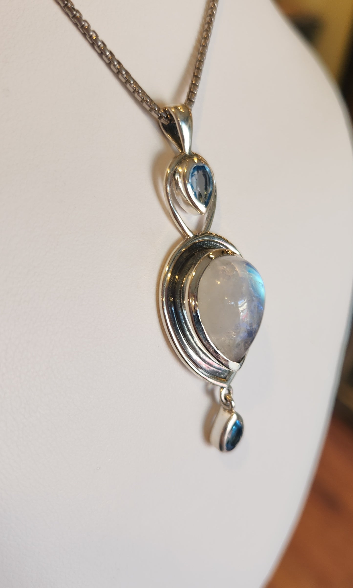 Sterling silver rainbow moonstone pendant with blue topaz