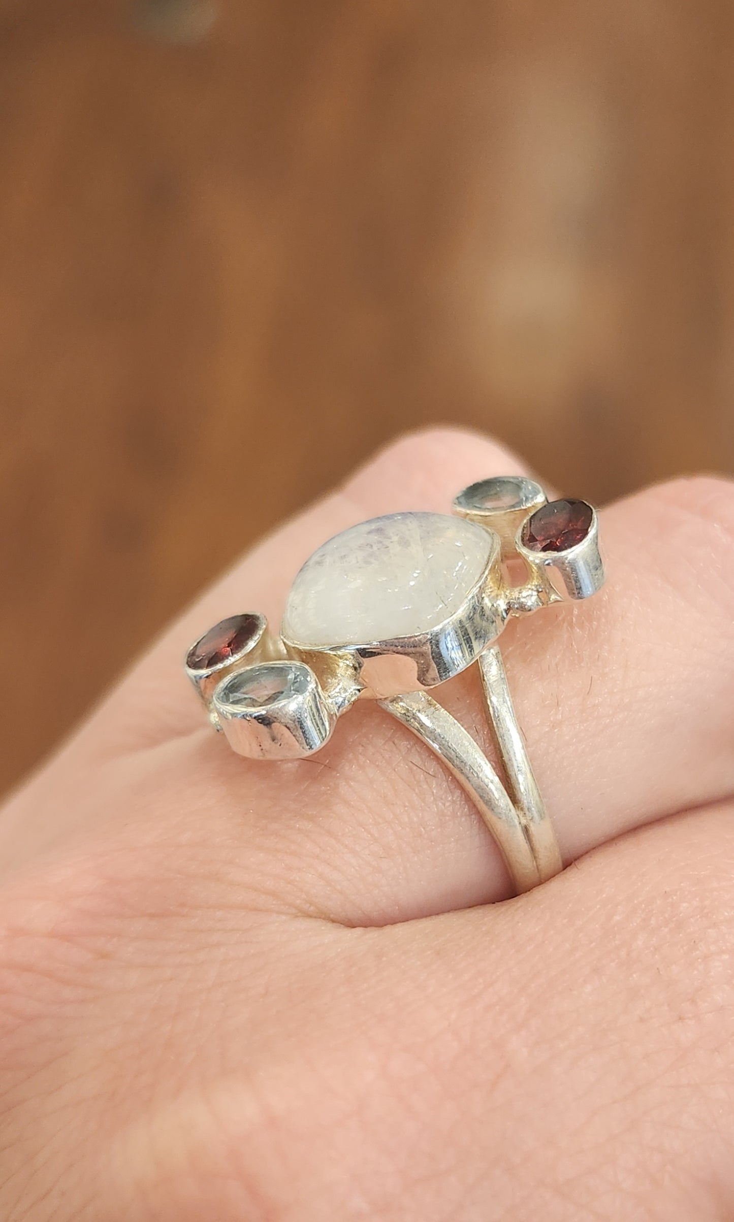 Sterling silver rainbow moonstone ring with garnet and blue topaz