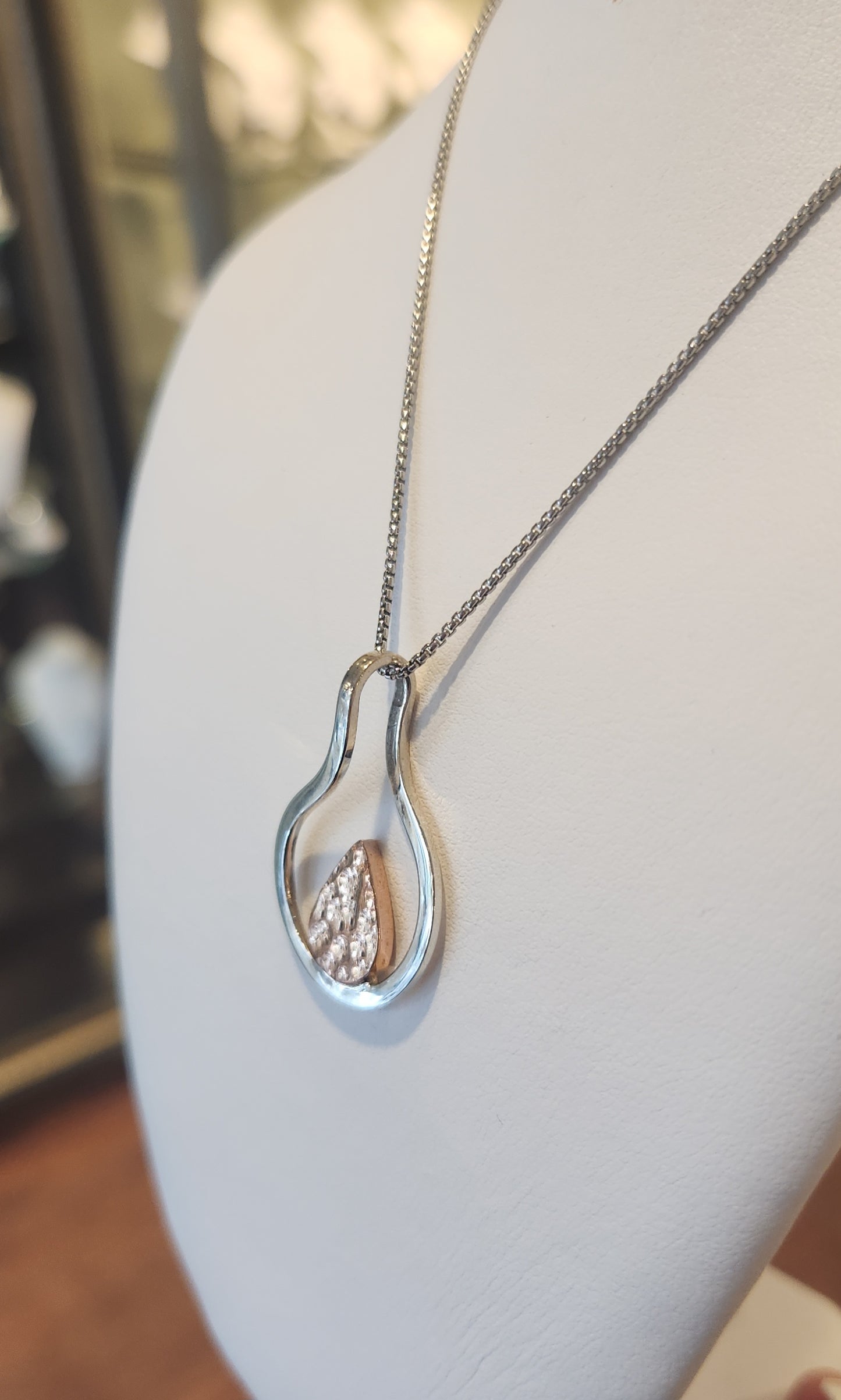 Sterling silver two-toned pendant featuring rose-colored texture