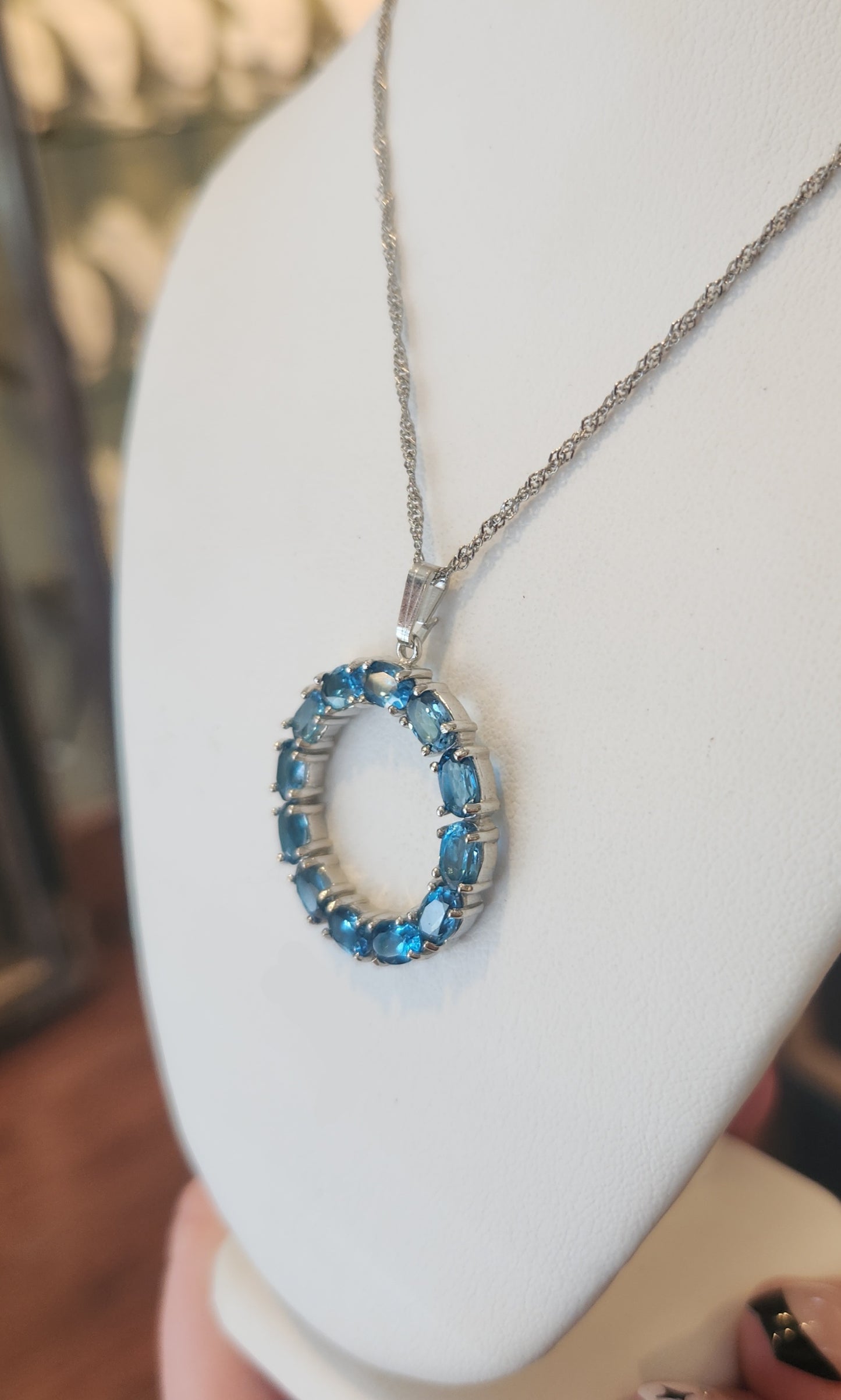 Sterling silver blue topaz circle pendant