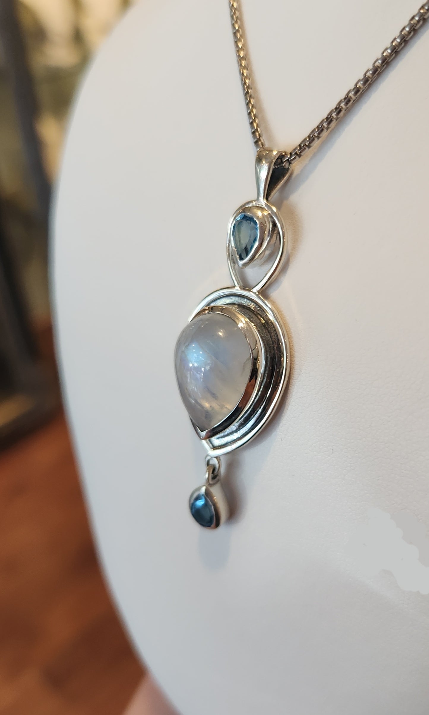 Sterling silver rainbow moonstone pendant with blue topaz