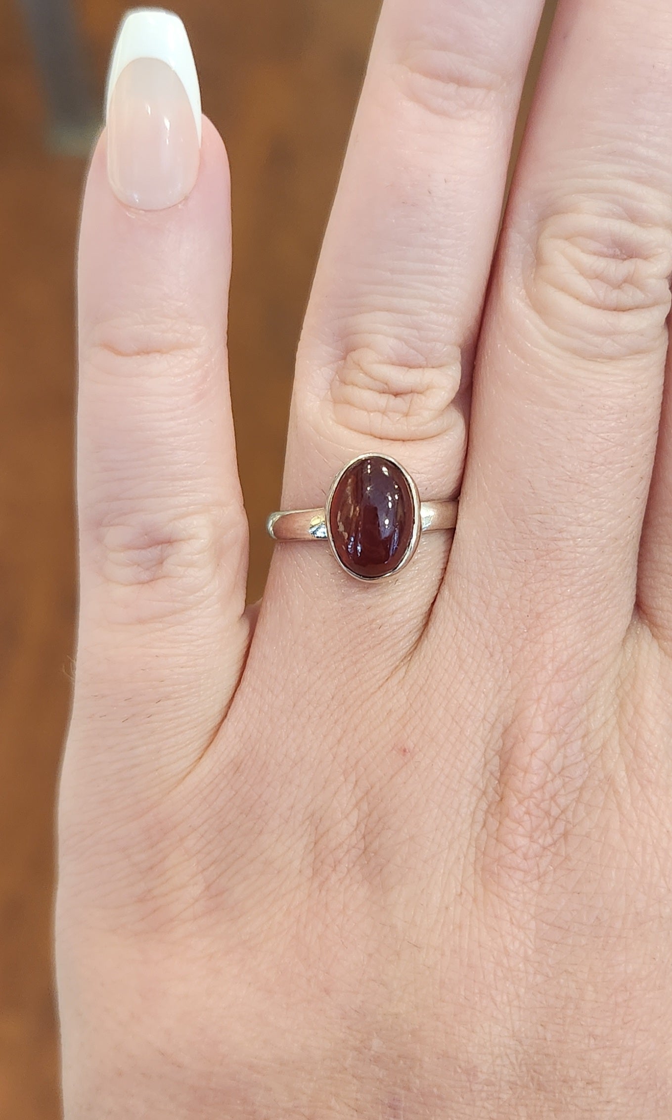 Sterling silver oval garnet bezel ring