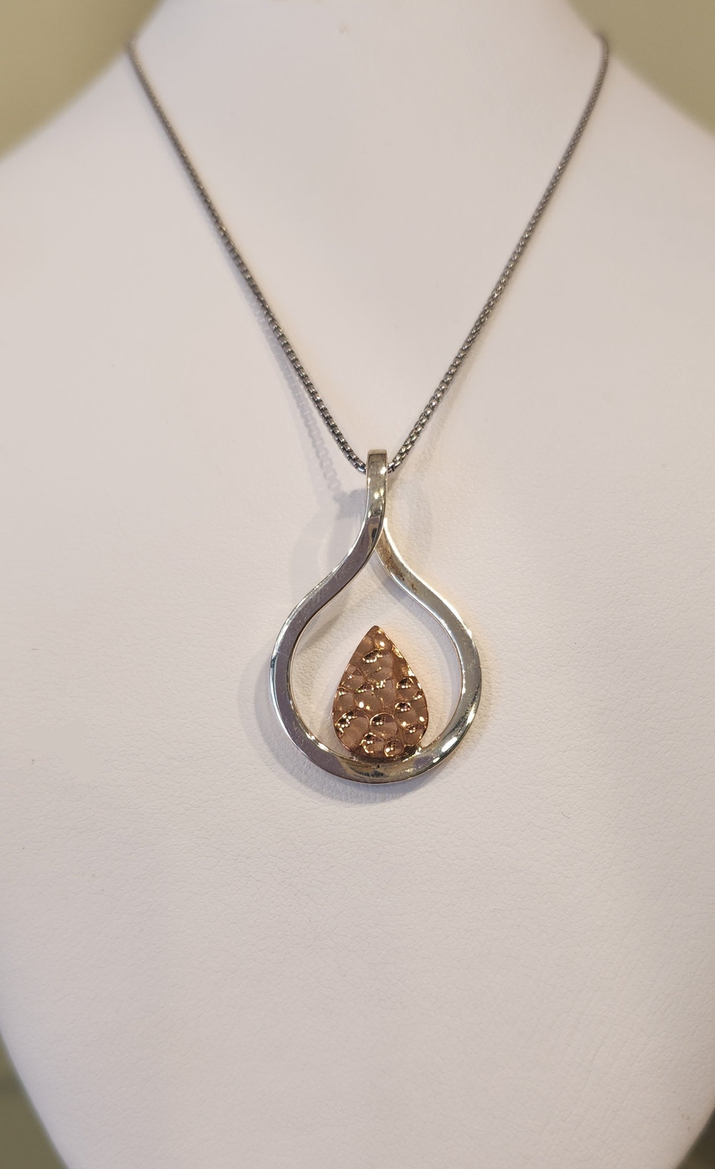 Sterling silver two-toned pendant featuring rose-colored texture